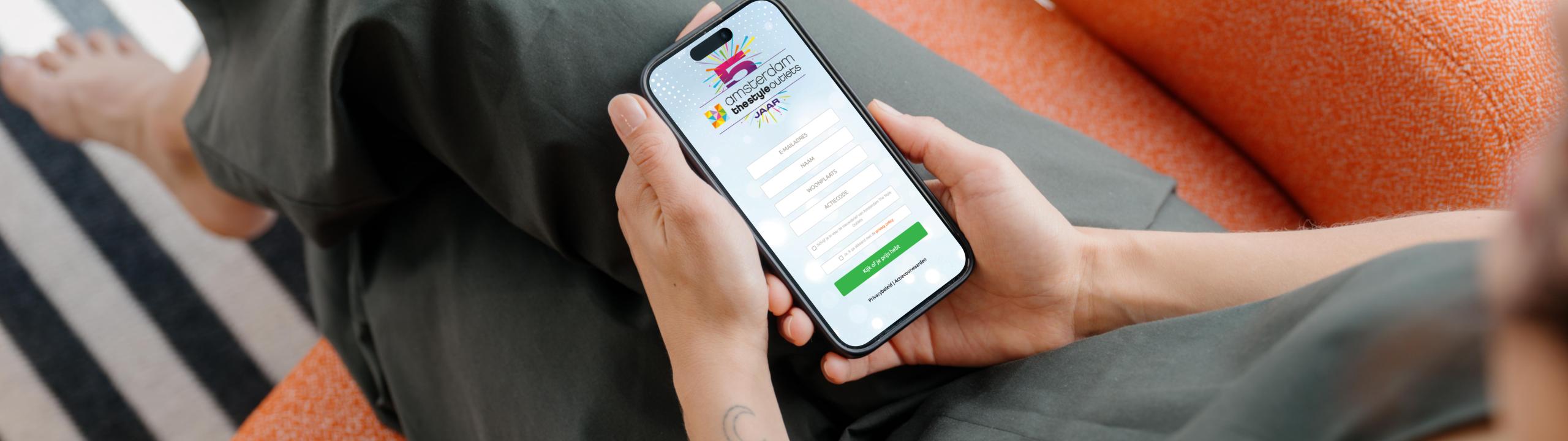 mockuuups-iphone-15-pro-mockup-in-a-womans-hand-on-a-cozy-couch